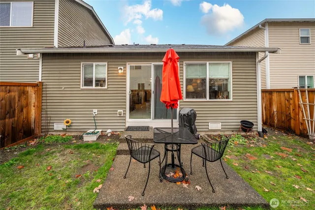 a view of two chairs in a backyard