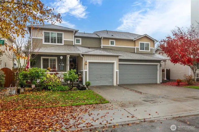 a front view of a house with a yard and garage