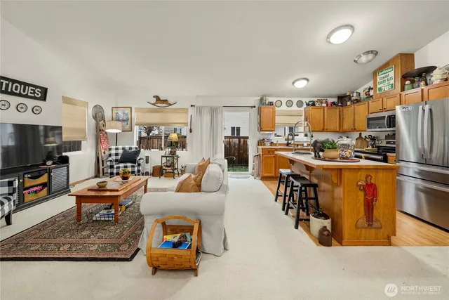 a very nice looking living room with kitchen and furniture