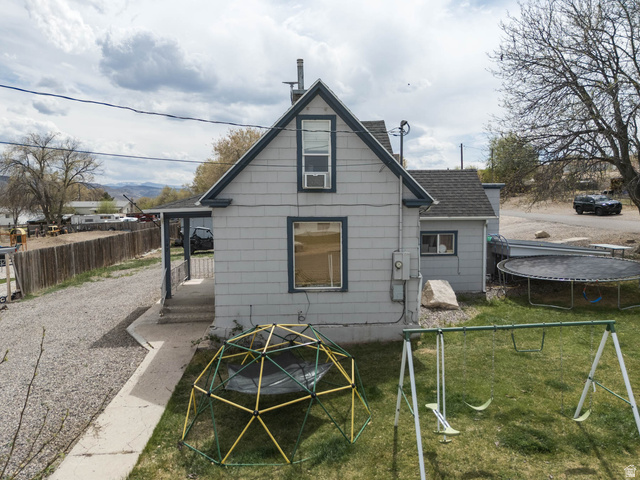 197 West 100 South Redmond, UT 84652 - Photo 28 of 41 Back of property with a trampoline, an outdoor fire pit, and a shingled roof