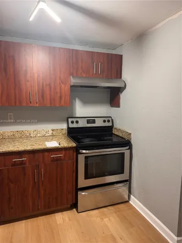 a stove top oven sitting inside of a kitchen