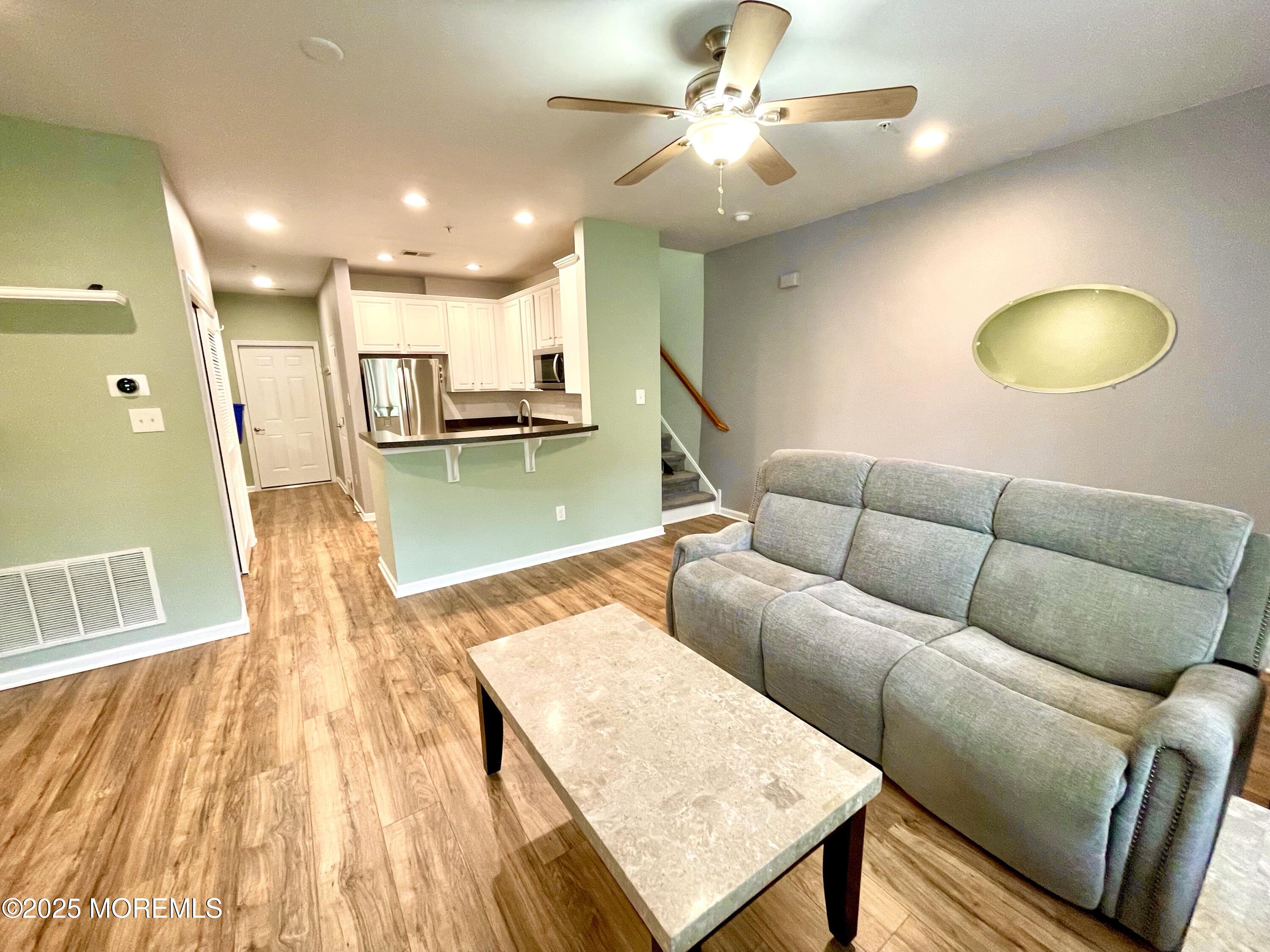 46 Michael Drive Tinton Falls, NJ 07712 - Photo 4 of 16 a living room with furniture and a wooden floor