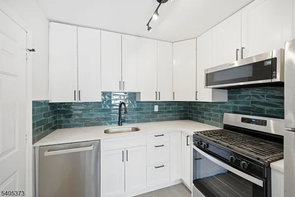 a kitchen with granite countertop a stove and a sink