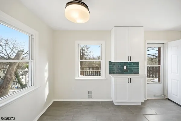 a view of a livingroom with wooden floor and a large window