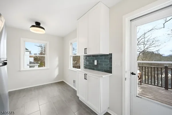a view of a livingroom with wooden floor and a window