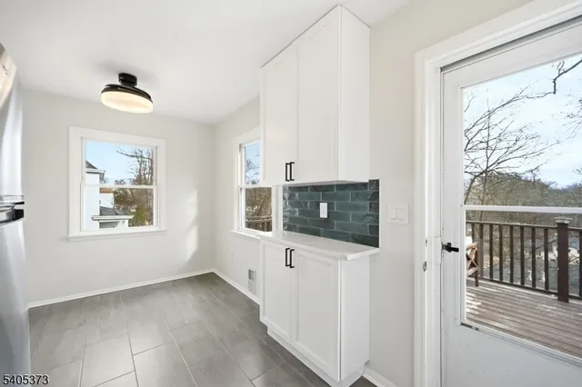 a view of a livingroom with wooden floor and a window