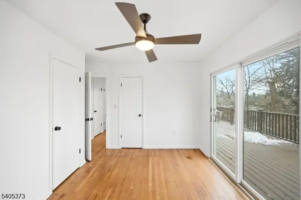 a view of hallway with a large window with wooden floor