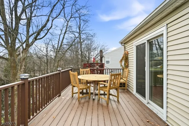 a view of a deck with table and chairs and wooden floor