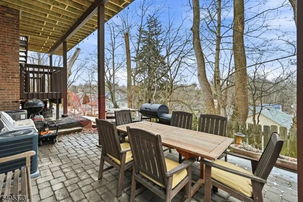 a view of a patio with a table chairs and a couple of chairs