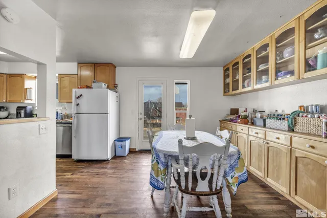 a view of kitchen with refrigerator and wooden floor