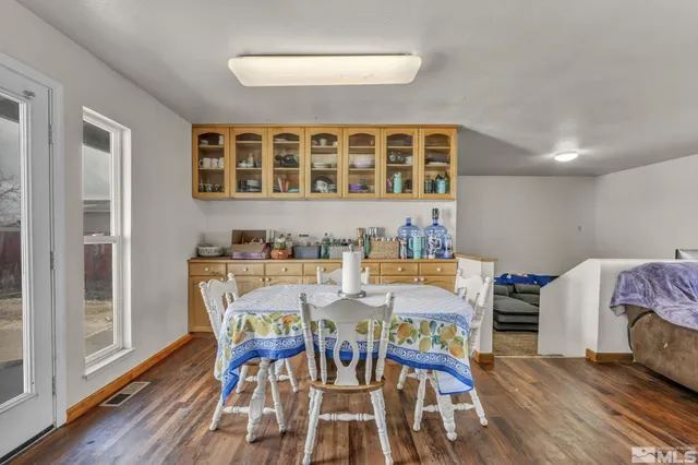 a view of a dining room with furniture and wooden floor