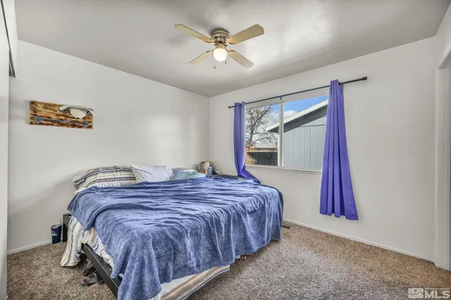 a bed sitting in a room next to a window