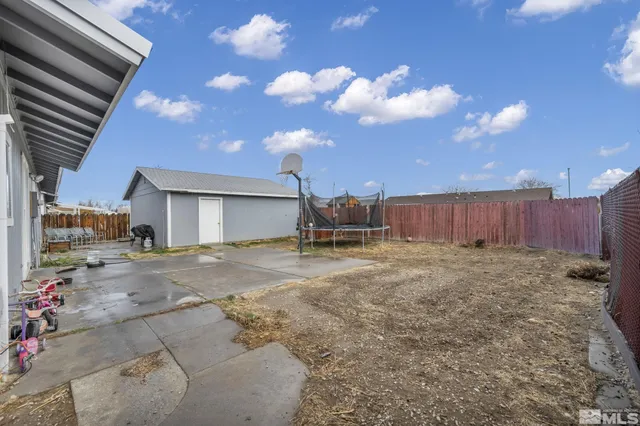 a view of a backyard with table and chairs and potted plants