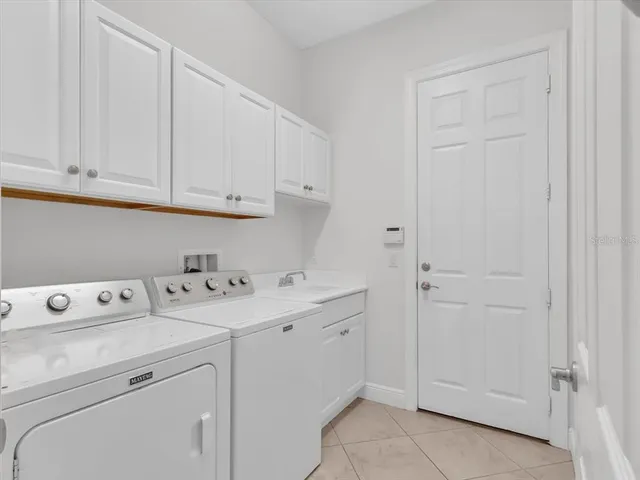 a bathroom with a bath tub a sink and a large mirror