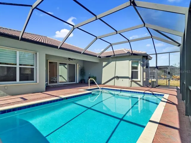 an aerial view of a house with a garden and houses