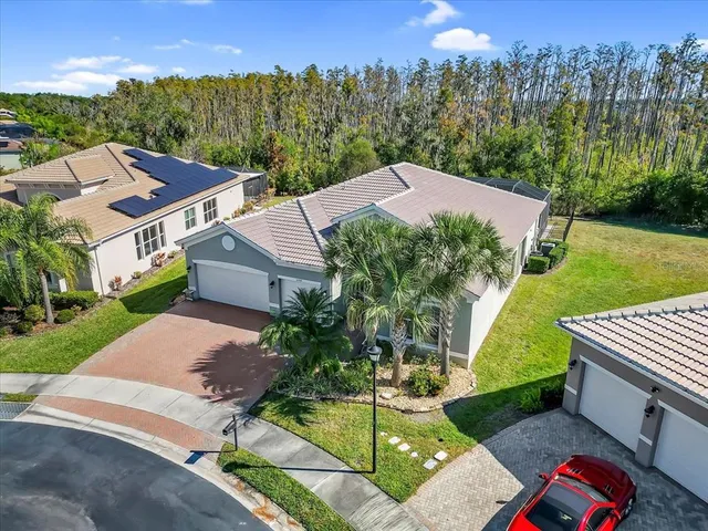 an aerial view of a house with swimming pool garden and patio
