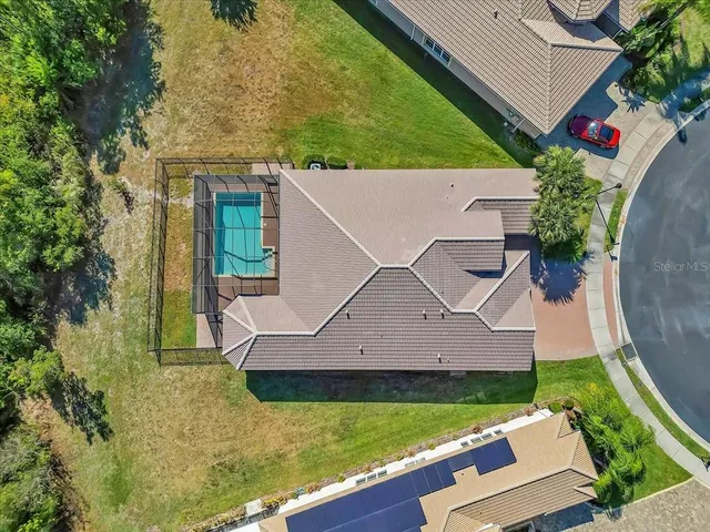 an aerial view of a house with yard swimming pool and outdoor seating