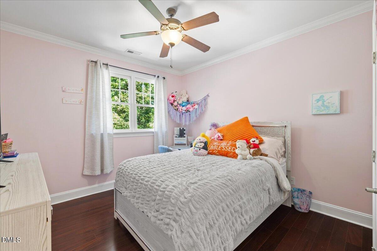 1304 Flying Hawk Road Apex, NC 27523 - Photo 24 of 52 a bedroom with a bed and a window