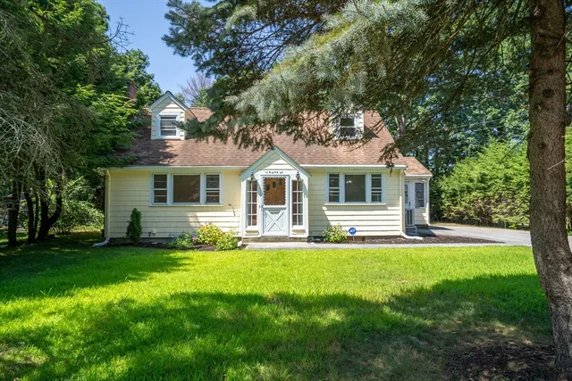 a front view of house with yard and green space