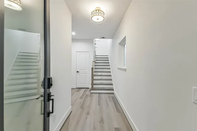 a kitchen that has a lot of cabinets in it and wooden floor