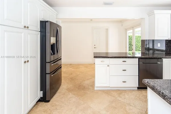 a kitchen with granite countertop a stove a sink and a granite counter top