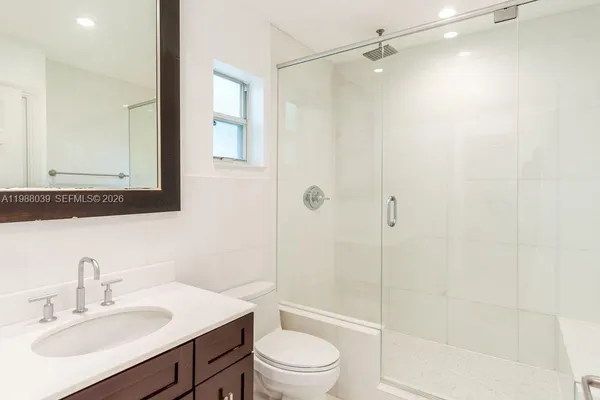 a bathroom with a bathtub a toilet and a shower