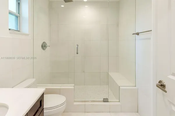 a view of a hallway with wooden floor and closet