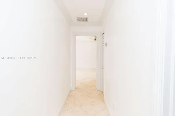 an empty room with windows and entrance