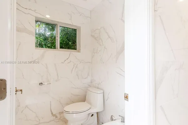 a view of an house with backyard space and balcony