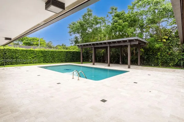 a view of house with backyard and sitting area