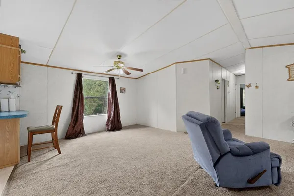 a livingroom with furniture and a large window