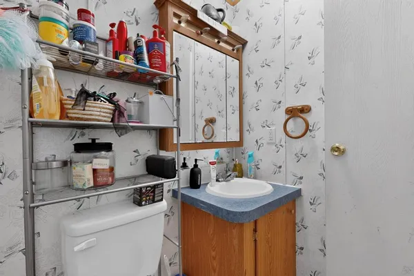 a kitchen with stainless steel appliances granite countertop a sink and a stove with chairs