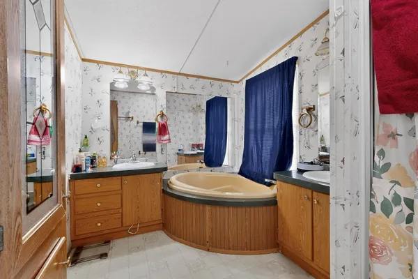 a bathroom with a sink a toilet and shower curtain