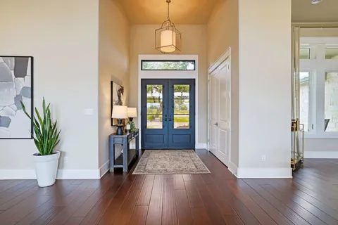 a view of an entryway with wooden floor