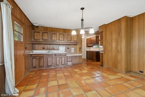 a kitchen with stainless steel appliances granite countertop a stove a sink dishwasher and a refrigerator with wooden floor