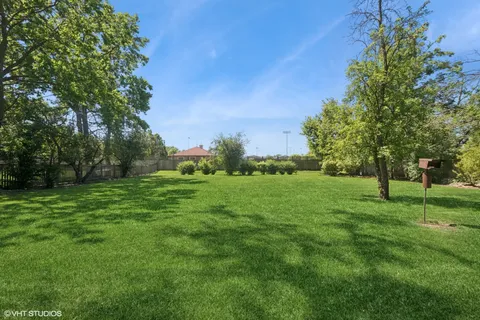 a view of grassy field with trees