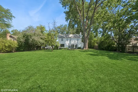 a view of an house with backyard space and garden