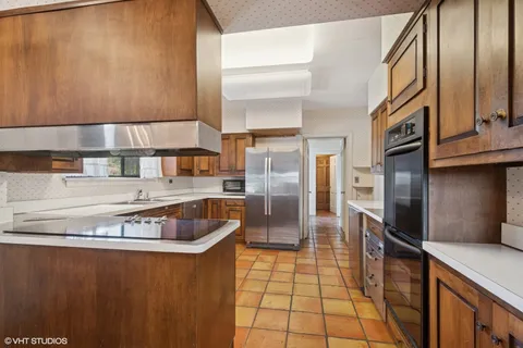 a kitchen with stainless steel appliances granite countertop a refrigerator and a stove