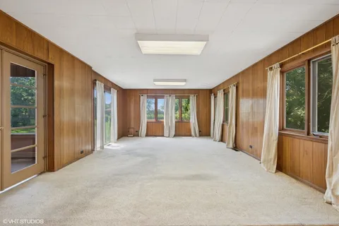a view of an empty room with large windows