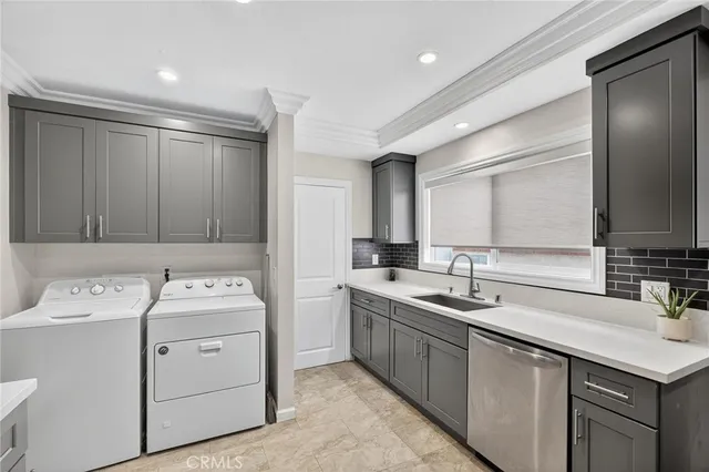 a view of a kitchen with a sink and dishwasher with wooden cabinets