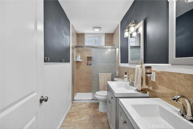 a bathroom with a sink and mirror with toilet