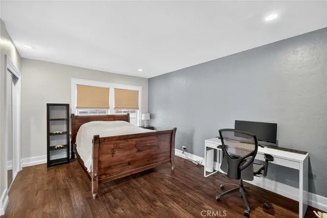 a bedroom with a bed and a desk