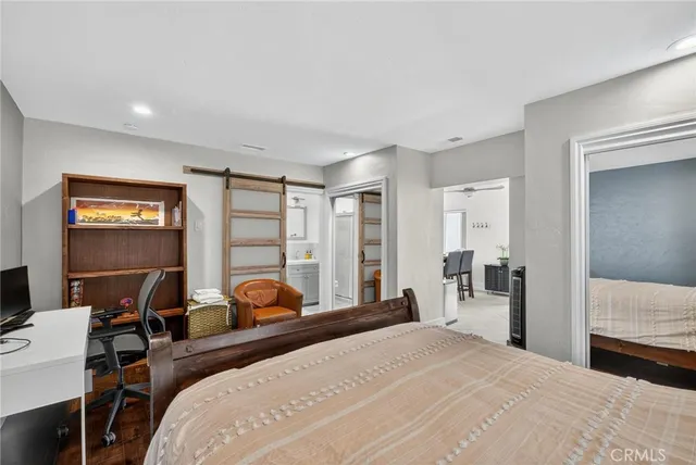 a bedroom with a bed and a lamp