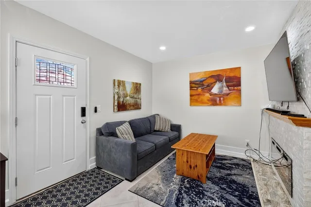 a living room with furniture a rug and a window