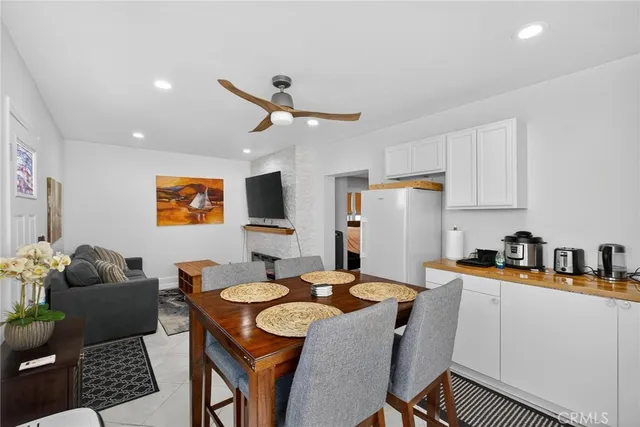 a kitchen with stainless steel appliances a dining table and chairs