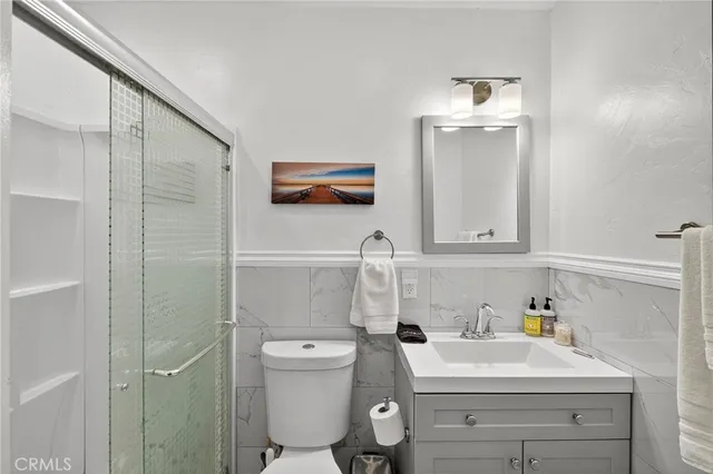 a bathroom with a sink a toilet and vanity