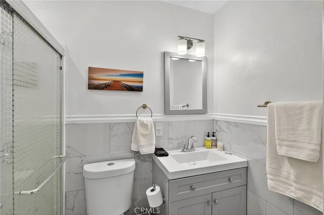 a bathroom with a sink a toilet and vanity