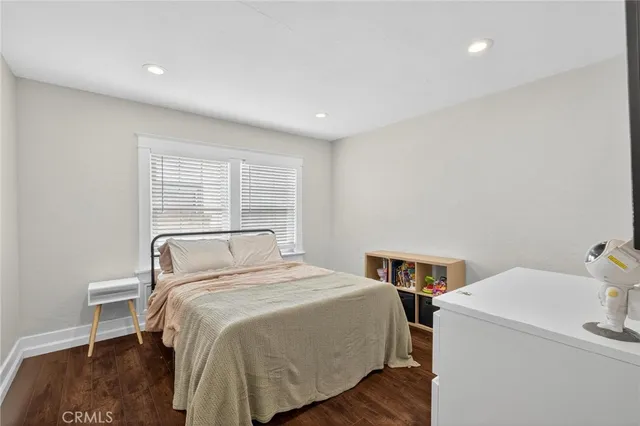 a bed sitting in a bedroom next to a window