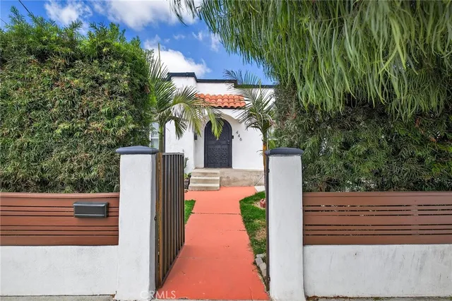 a view of a patio with table and chairs with wooden floor and fence