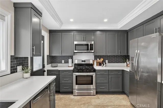 a kitchen with a refrigerator stove and sink